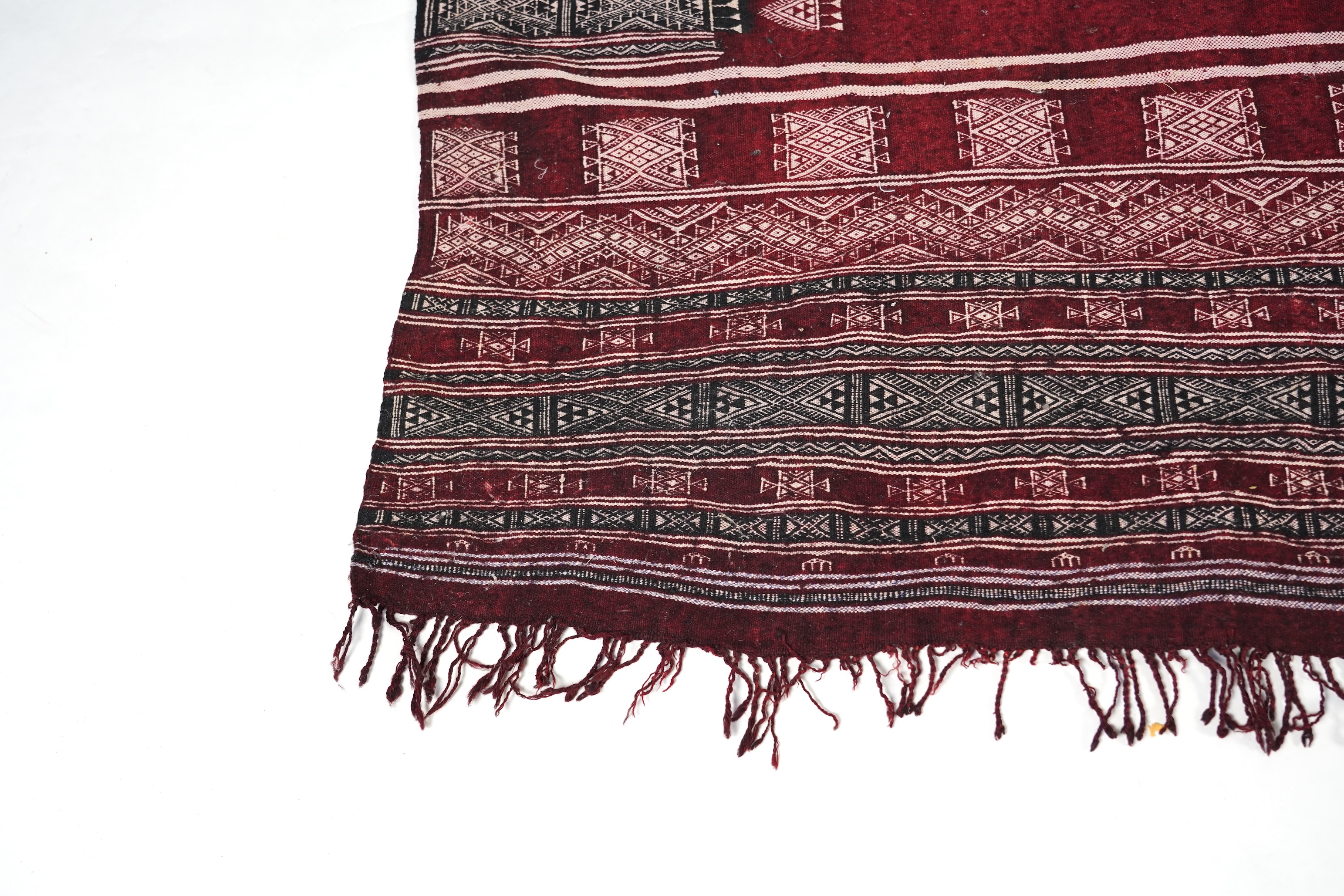 A Tunisian Amazigh, Berber maroon and white woven wool wall hanging, possibly 107 x 125cm